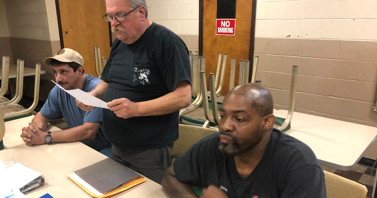 Local 683 President Seidler reviewing the settlement during the ratification meeting, with Financial Secretary Robert Foulk (left) and Chief Steward Malcolm Toran (right).