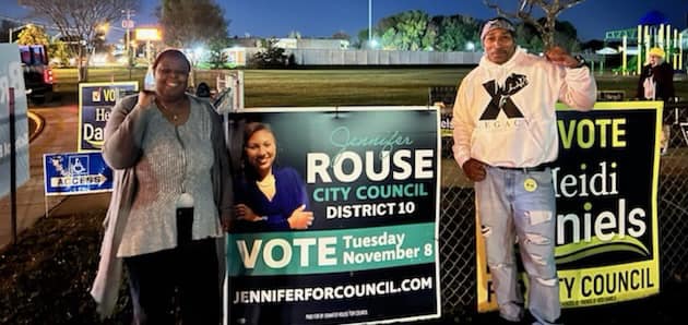Two members posing with Jennifer Rouse for City Council sign